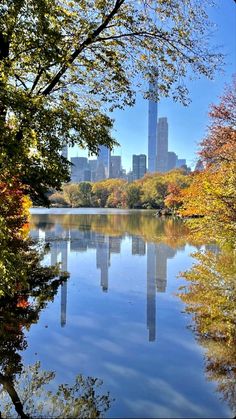 the city skyline is reflected in the still waters of central park's lake michigan