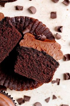 two chocolate cupcakes with one cut in half