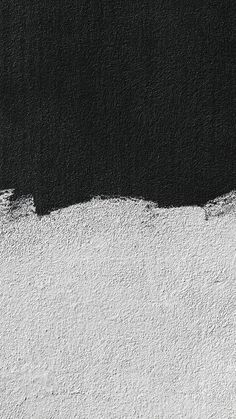 a black and white wall with some paint on it