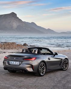 the bmw z4 roadster is parked on the beach