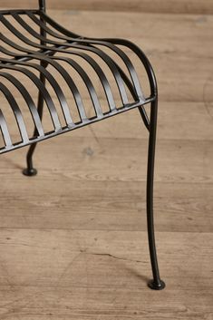 a metal bench sitting on top of a hard wood floor