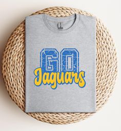 This T-Shirt is perfect for tailgating, game days or any casual occasion. It's a must-have for Southern fans and would make an excellent gift for family and friends. Geaux Jags!    ➡️This is a DTF print (Direct to Film) heat pressed onto garment.  ➡️T-shirt Brands: Gildan Soft Style, Hanes or Jerzee at this time.  ➡️Unisex Sizing - True to size, but for a trendy, oversized look, we recommend sizing up.  Please note: Colors in listings might vary slightly based on your device and print size may d Casual Sublimation Design With Team Logo For Fans, Gray Fan Apparel Top For Game Day, Gray Fan Apparel Tops For Game Day, Athletic Heather Graphic Tee With Letter Print, Sublimation Crew Neck T-shirt With Letter Print For Fans, Casual Sublimation Design With Team Logo For Fan Merchandise, Crew Neck Sublimation T-shirt With Letter Print For Fans, Gray Letter Print Tops For Fan Gear, Casual Sublimation T-shirt For Fan Merchandise