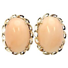 These lovely coral earrings offer an understated vintage elegance. The light pink cabochon stones are surrounded by a scalloped rose gold trim. They are simple yet chic and can be dressed up or down. Metal: 18K Rose Gold Natural Coral: 59.25 carat total weight Weight: 27.94 grams Length: 30 mm Width: 23 mm Height: 12 mm Stamped: 18K Backings: Post and Hinged Back Estate Condition: Excellent, professionally cleaned and polished Appraisal Value: $2,500.00 Coral Earrings, Natural Coral, Vintage Elegance, Antique Earrings, Pearl Stud Earrings, Pearl Studs, Oval Cabochon, Color Rosa, 18k Rose Gold