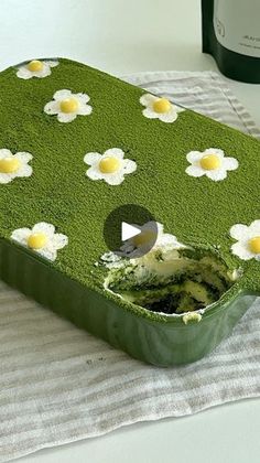 the cake is decorated with daisies and has been cut in half to show it's interior