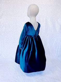 a mannequin wearing a blue dress on a white background