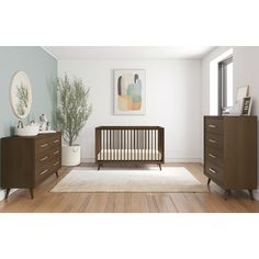 a baby crib and dresser in a room