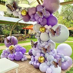 balloons and butterflies are arranged on the ground