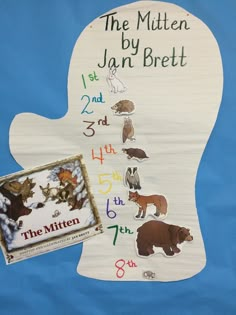 the mitten by jan breit is next to an activity book for children's numbers