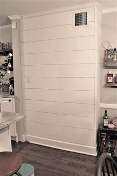 a kitchen with white walls and wooden floors