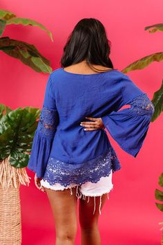 We think you'll agree when we tell you how "haute" this charming royal blue top is featuring lightweight breezy material with intricate semi-sheer crochet detailing, a v-cut neckline with a tie closure, long oversized sleeves with ultra flared forearm cuffs, and a relaxed silhouette that falls into a scalloped tunic length hemline! Bohemian V-neck Lace Top For Vacation, Blue Lace Patchwork Spring Tops, Blue Bohemian Top With Crochet Trim, Spring Blue Top With Lace Patchwork, Bohemian V-neck Lace Top For Day Out, Blue Crochet Lace Top For Vacation, Vacation Lace Trim V-neck Top, Blue Tops With Lace Trim For Vacation, Bohemian Blue Crochet Top With Crochet Trim