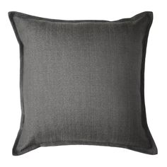 a dark gray pillow on a white background