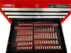 a red and black machine with lots of screws in it's tray,