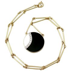 An impressive vintage black onyx and mother of pearl, 0.22 carat diamond and 18k yellow and white gold necklace; part of our diverse gemstone jewelry and estate jewelry collections. This fine and impressive vintage pendant has been crafted in 18k yellow gold with an 18k white gold setting. The circular frame is ornamented with a shaped black onyx and mother of pearl panel, bezel set. A curved 18k white gold linear setting ornamented the join between the two gemstone panels, and is embellished wi Art Deco Pendant Necklace, Butterfly Necklace Gold, Pearl And Diamond Necklace, Mother Of Pearl Jewelry, White Gold Necklace, White Gold Set, Yellow Gold Necklace, Antique Pendant, White Gold Necklaces