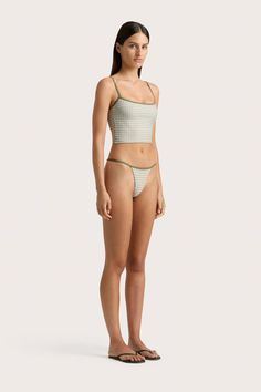 A fitted swim top, cropped just above the waist. Printed in Oliander Floral with adjustable Khaki straps, pair with the Manon Bikini Bottom or style as ready-to-wear with a relaxed pair of trousers. Adjustable Straps Crop Top For Loungewear, Fitted Cropped Bottoms For Vacation, Seamless Cropped Summer Bottoms, Summer Triangle Crop Top For Loungewear, Summer Triangle Top Crop Top For Loungewear, Fitted Triangle Top Crop Top For Loungewear, Cropped Seamless Summer Bottoms, Summer Cropped Bottoms For Poolside, Fitted Seamless Cropped Bottoms