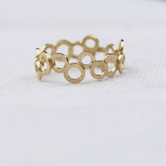 "Very chic and trendy jewelry piece, this gold filled ring is handmade with a unique and stylish design. A chic piece you can wear with other dainty, stacking rings to create your own wonderful style. Why purchase this gold ring? One you can wear on an everyday basis and mix or match with other pieces✅ The ring is expertly handmade with craftsmanship and high-quality materials ✅ Available in ring sizes 5 to 10 ½ US ✅ Wearable alone or with other stacking ring pieces ✅ Thoughtfully packaged in a Gold Midi Rings For Promise, Round Shape, Hypoallergenic Gold Plated Round Rings, Hypoallergenic Gold-plated Rings, Gold Stackable Rings Made Of Recycled Gold, Modern Gold Stackable Rings, Yellow Gold Circular Jewelry With Ring Detail, Recycled Gold Round Rings, Simple Round Recycled Gold Rings, Simple Design Recycled Gold Rings