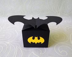 an origami box with a batman symbol on the front and bat logo on the back