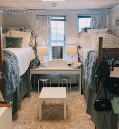 two beds in a room with lights on the ceiling and carpeted floor, one is white