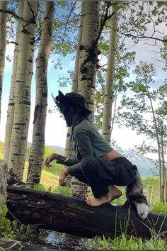 a person in costume jumping over a log