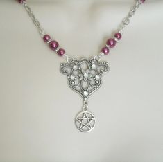 Pink Pentacle Necklace This beautiful necklace has pink glass pearl beads, seed beads, silver plated accent beads, silver plated chain, silver plated filigree pendant with rhinestones and a pewter silver pentacle. 20 inches long. Silver plated lobster clasp. The pendant is 1.5 inches wide and 1.5 inches long.  wiccan pagan wicca goddess witchcraft pentagram witch gothic witchy woman style Mystical Silver Necklace With Round Beads, Handmade Pink Gothic Jewelry, Pink Gothic Jewelry, Goddess Witchcraft, Wicca Goddess, Pentacle Necklace, Wicca Jewelry, Pagan Necklace, Wiccan Necklace