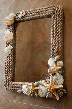 a rope frame with seashells and starfish on it