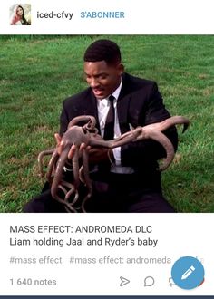 a man in a suit and tie holding an octopus on top of his lap with the caption mass effect andromeda dlc