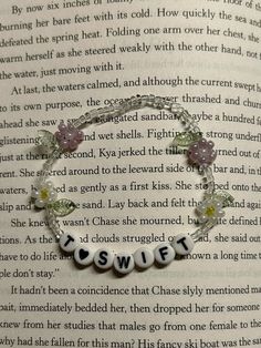 an open book with a bracelet that says swiff on the front and back of it