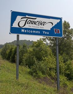 a blue and white sign that says townes the villagers state welcomes you