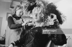 a woman getting her hair styled by another woman