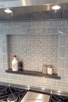 a stove top oven sitting inside of a kitchen next to a wall mounted range hood