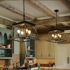 three lights hanging over a kitchen island in a room with wooden floors and beams on the ceiling