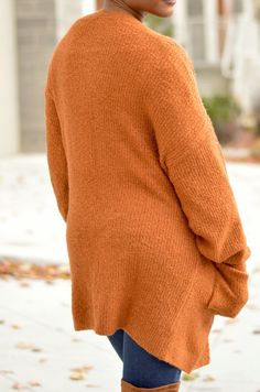 Add this rust colored cardigan to any ensemble for a nice cozy feeling. Two Pockets Model is wearing a Small Brown Knitted V-neck Cardigan, Brown V-neck Cardigan For Layering, Brown V-neck Cardigan For Loungewear, Fall Cardigan For Loungewear, Fall Loungewear Cardigan, Cozy Brown Long Sleeve Cardigan, Brown Soft Knit Cardigan For Loungewear, Cozy Sweater With Soft Texture For Fall, Orange Sweater For Fall Layering