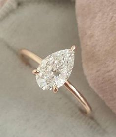 a ring with a pear shaped diamond on it