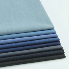 four different shades of blue and black folded on top of each other, one in the middle