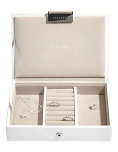 an open white box with jewelry in it