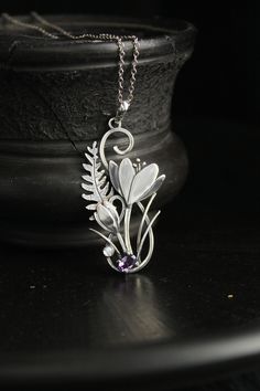 ITEM DESCRIPTION: The size H 5 cm x W 3 cm (2 x 1 inch). Weight - 4 g. You can buy it with a silver chain or without it. I made this unique Crocus pendant of sterling silver, dark amethyst, and moonstone. This is similar to the first spring flowers that appear from under the snow. The floral necklace looks so gentle and elegant! This handmade necklace will come to you in a gift box - ready for gifting. The parcel will be sent 1-2 days after payment. Delivery usually takes 10-21 days. But in the Spring Flower-shaped Jewelry Gift, Nature-inspired Flower Pendant Jewelry For Mother's Day, Unique Flower-shaped Jewelry With Flower Charm, Spring Birth Flower Jewelry, Spring Sterling Silver Jewelry With Flower Charm, Silver Necklace With Flower Charm For Spring, Silver Necklaces With Flower Charm For Spring, Spring Flower Pendant Jewelry Gift, Nature-inspired Flower Charm Pendant Necklace