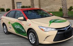 a car that is sitting in the street with arabic writing on it's side