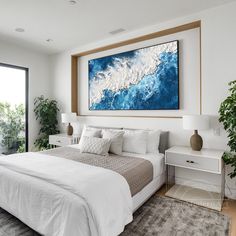 a large painting hanging above a bed in a room with white walls and flooring