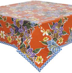 an orange table cloth with flowers on it