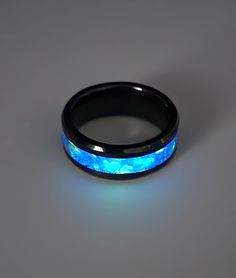 Custom made black ceramic ring.  Inlaid with the highest quality ultra violet reactive glow powder and glow glitter.  Comes in a black velvet gift box with a UV keychain light. Band is 8mm wide, available in multiple sizes Perfect for wedding bands, Valentine's day gifts, birthdays, Christmas, or any occasion. Personalize with free engraving inside the band Engraving available in a variety of fonts.  See third picture for font selection Find more selections in my shop: essentialjewels2022.etsy.c Magical Luminous Blue Jewelry, Luminous Ring Jewelry For Gifts, Magical Black Jewelry For Gifts, Blue Luminous Jewelry For Party, Luminous Blue Jewelry For Parties, Luminous Ring Jewelry As A Gift, Glow In The Dark Black Jewelry For Gift, Black Glow In The Dark Jewelry For Parties, Black Glow In The Dark Party Jewelry