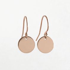 SUPER CUTE ALERT!! Warning, these earrings are dainty and sooooo cute! These earrings are perfect for the minimalist jewelry lover. Available in a smooth shiny version or a hammered version for extra sparkle. These earrings feature a small 14k rose gold filled disc on a 14k rose gold fill ear wire. The disc is about 1/3 inches, so very small. The total drop on these earrings is about .75 inches. Your new earrings will arrive in a gift box. Please feel free to email me with any questions. These e Dainty Single Rose Gold Earring, Minimalist Rose Gold Round Earrings, Tiny Rose Gold 14k Earrings, Minimalist Rose Gold Circle Earrings, Handmade 14k Rose Gold-filled Earrings, Gold Dots, Dainty Earrings, Simple Earrings, Ear Wire