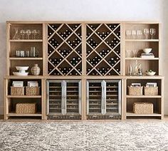 a living room filled with lots of furniture and wine glasses on top of it's shelves