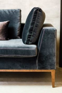 a black couch with two pillows on it