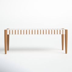 a bench made out of wood and white fabric on the bottom, with two legs