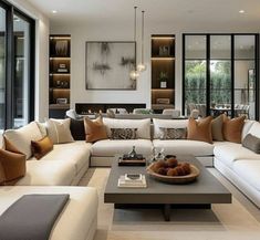 a living room filled with white couches and lots of pillows on top of it