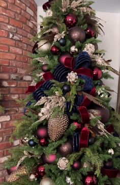 a decorated christmas tree with red, white and blue ornaments on it's branches