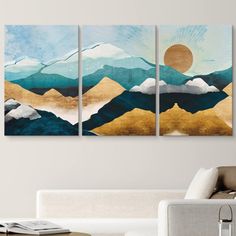 three paintings on the wall in a living room