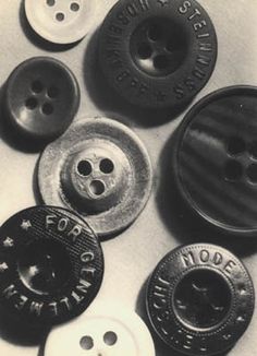 black and white photograph of buttons on a table