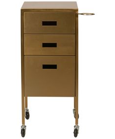 a gold metal filing cabinet with three drawers on casteors and two black knobs