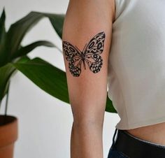 a woman with a butterfly tattoo on her arm