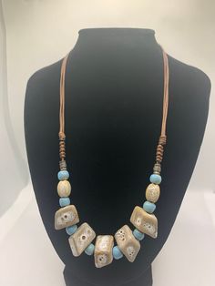 Elegant handmade ceramic beaded necklace suitable for any style and occasion. It's unique beads are light weight and eye catching with a beautiful shine. The sliding knot closure creates a clean fastening that allows you to adjust the necklace to your likening.   It comes nicely packed in a beautiful gold string jewelry bag. The colors are blue and beige with unique patterns. It's 10 inches in length and adjust up to 14 inches long. **KEEP IN MIND** Every stone is handmade, so slight differences Adjustable Everyday Wooden Beaded Necklace, Adjustable Large Beads Necklace For Everyday, Casual Adjustable Large Beads Necklace, Casual Adjustable Beaded Necklace With Large Beads, Casual Adjustable Necklace With Round Beads, Ceramic Beads Necklace, String Jewelry, Sliding Knot Closure, Sliding Knot